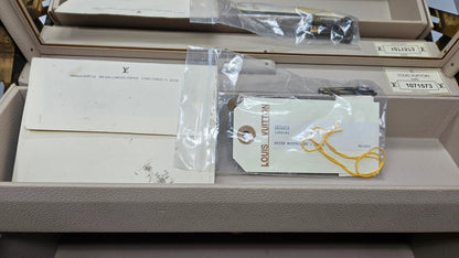 Louis Vuitton packaging with tags and documents inside a box