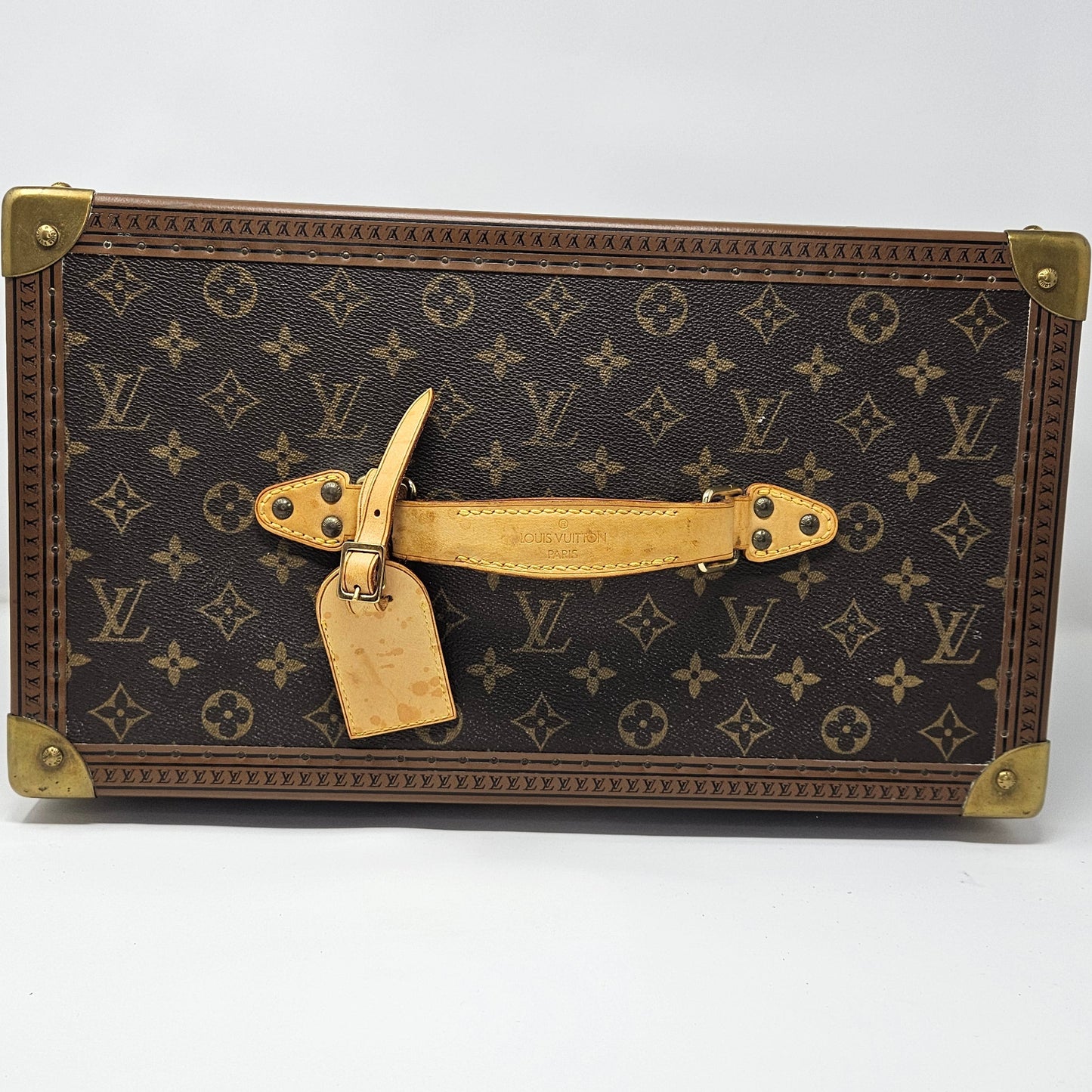 Vintage-style suitcase with monogram pattern on a white background