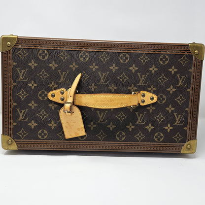 Vintage-style suitcase with monogram pattern on a white background