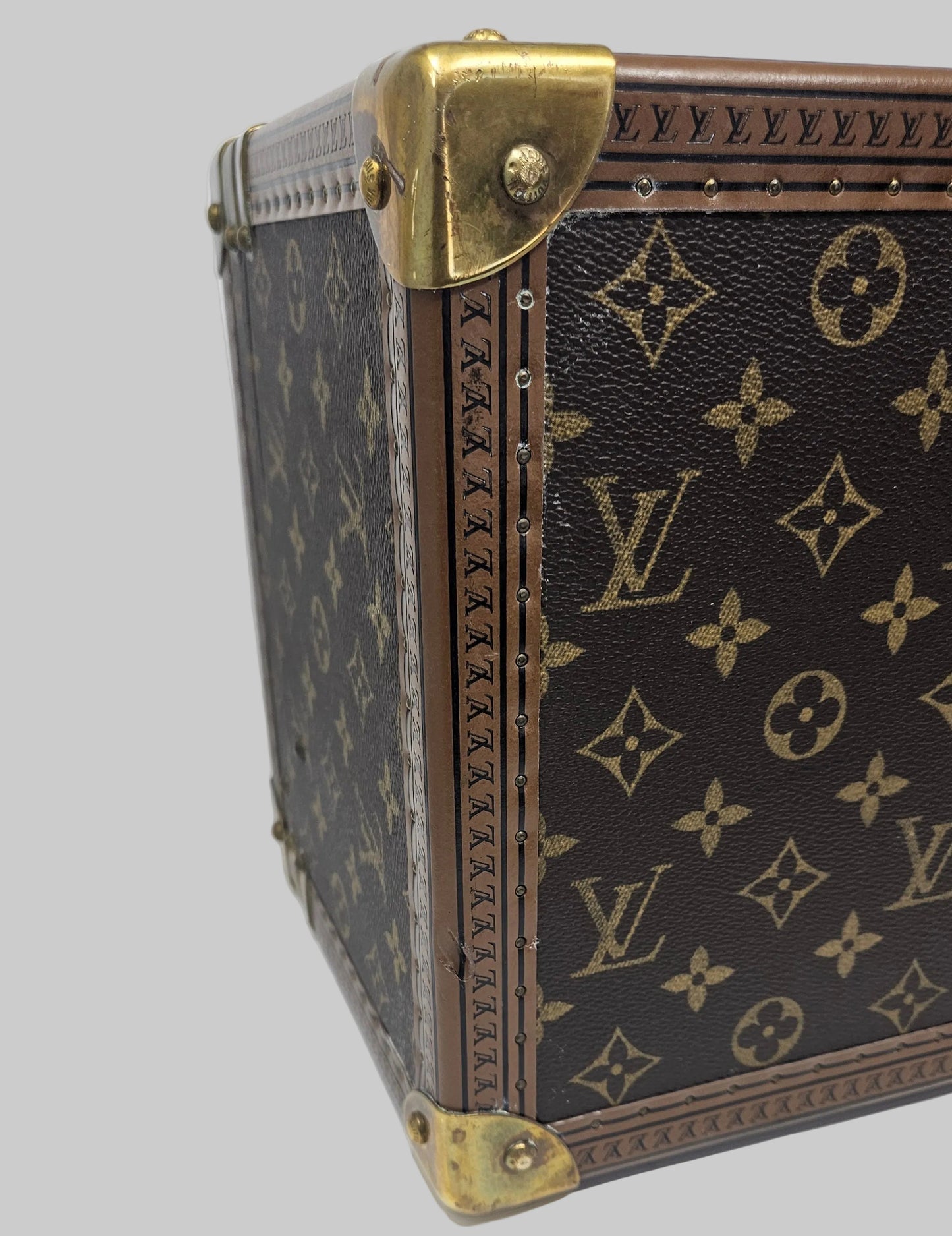 Louis Vuitton suitcase with monogram pattern on a white background