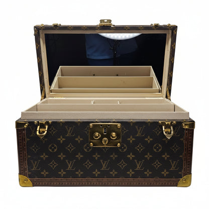 Open Louis Vuitton Vanity  box with monogram pattern on a white background