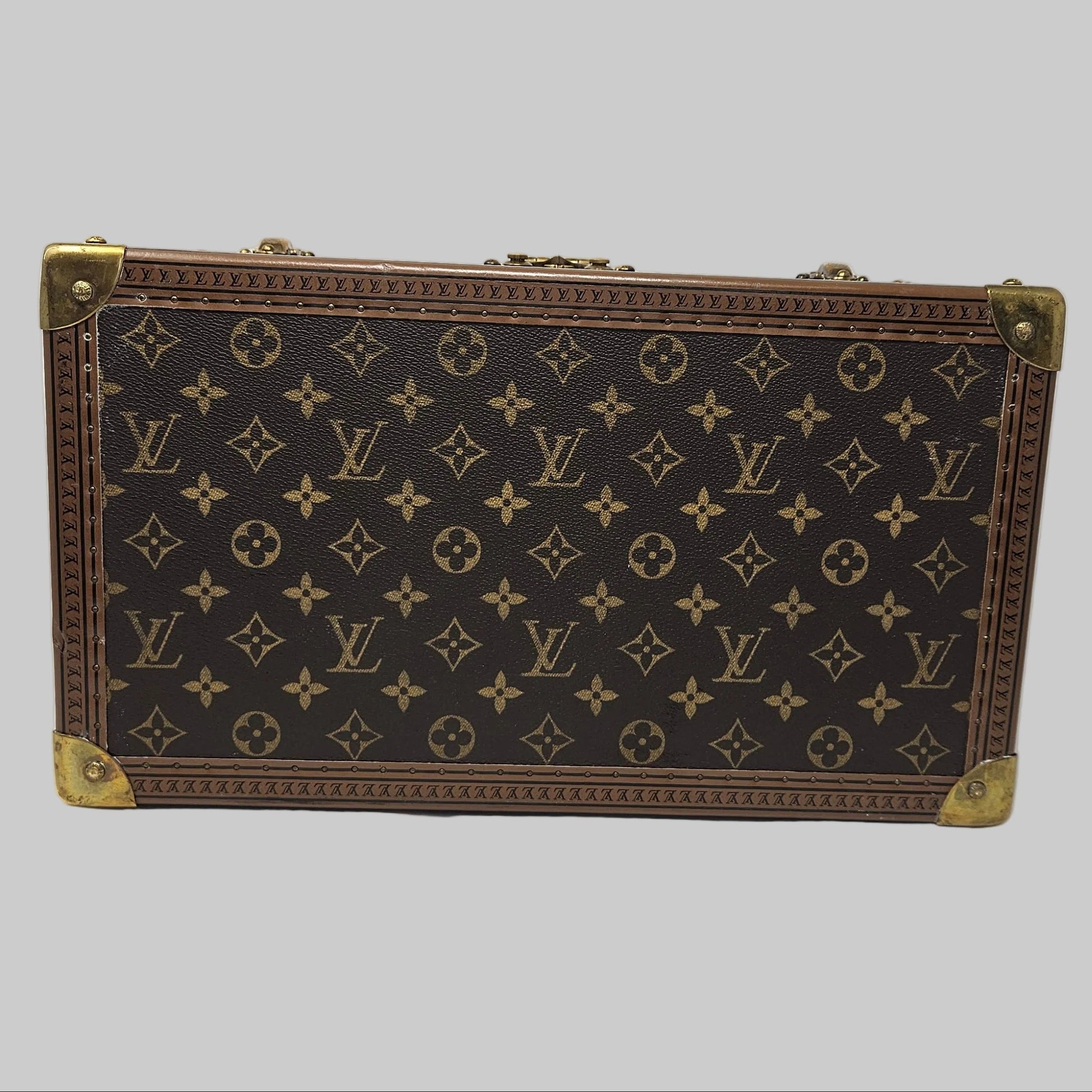 Louis Vuitton suitcase with monogram pattern on a white background