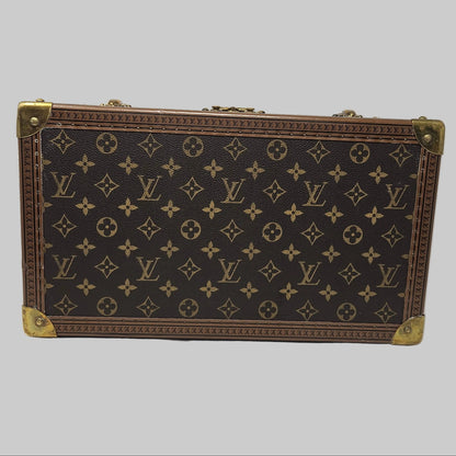 Louis Vuitton suitcase with monogram pattern on a white background
