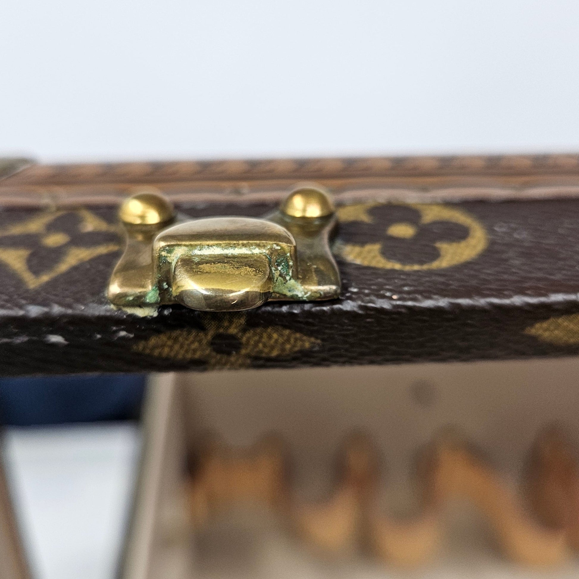 Close-up of a decorative box with gold accents on a white background