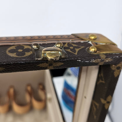 Close-up of a Louis Vuitton jewelry box with a mirror on a white background
