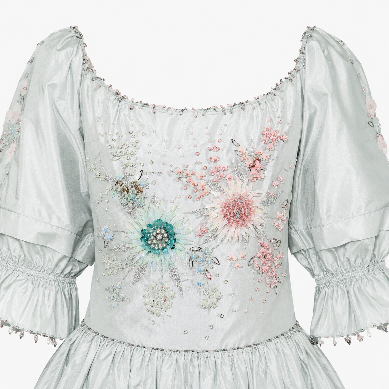 White dress with floral embroidery and embellishments on a white background