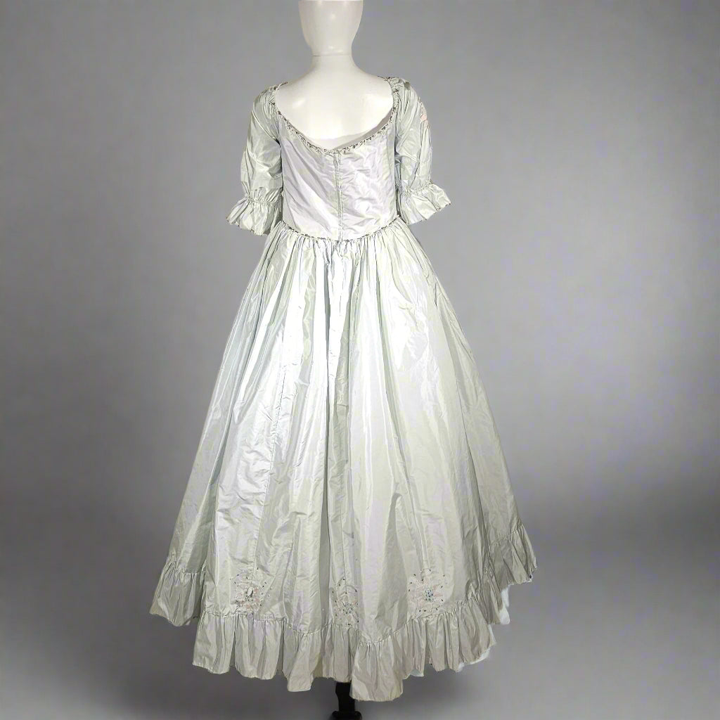 Vintage-style white dress on a mannequin against a plain background