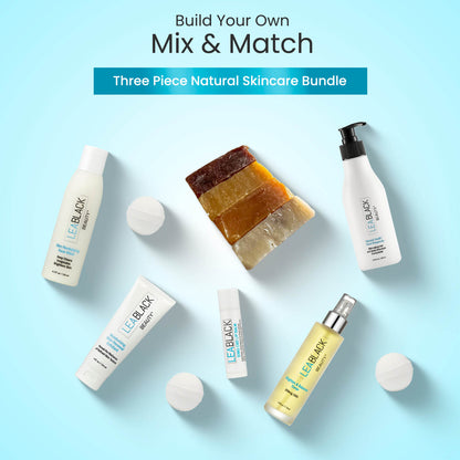 Three-piece natural skincare bundle with bottles and soap on a light blue background