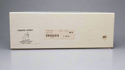 Pierre Hardy shoe box on a dark fabric background