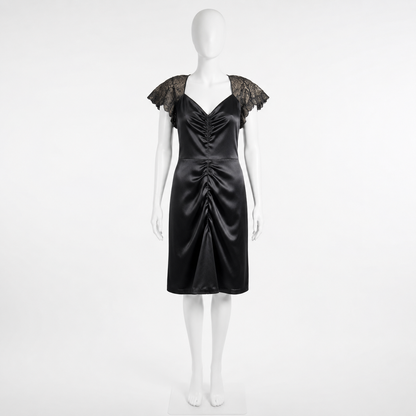 Black satin dress with lace sleeves on a mannequin against a white background