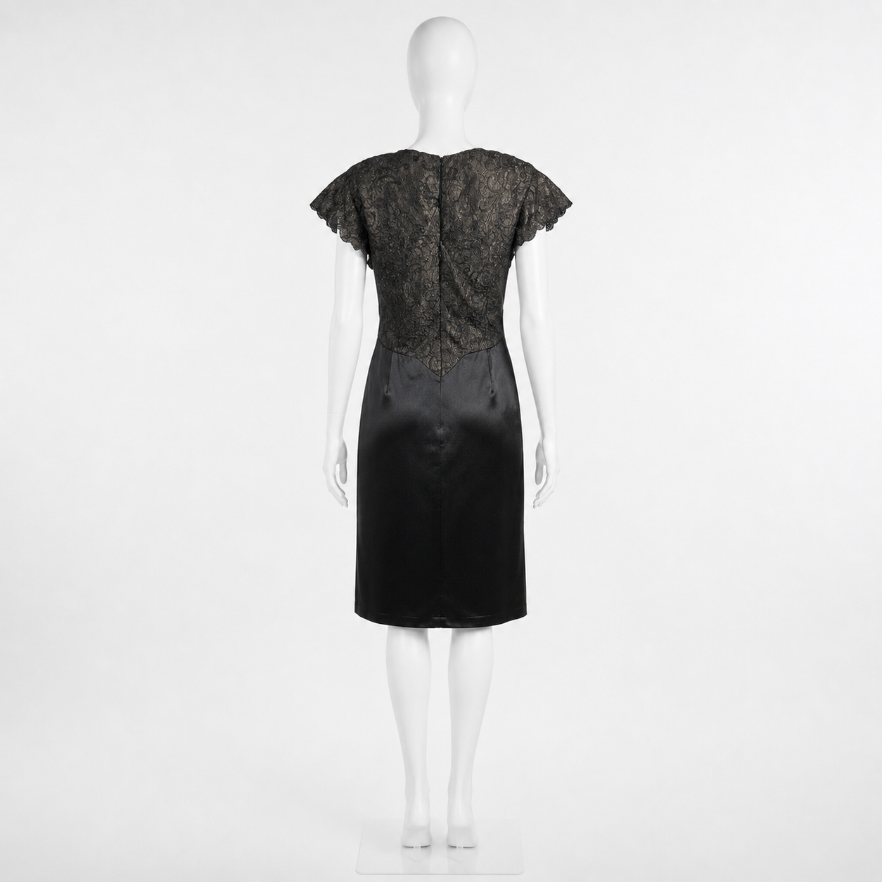 Black dress on a mannequin against a white background