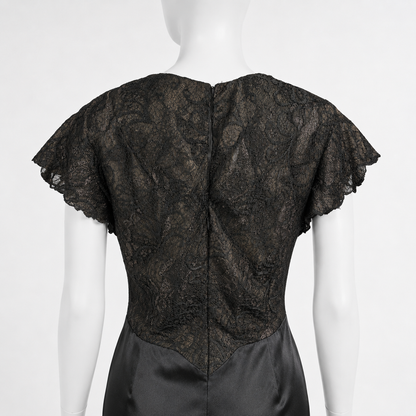 Black lace top on a mannequin against a white background