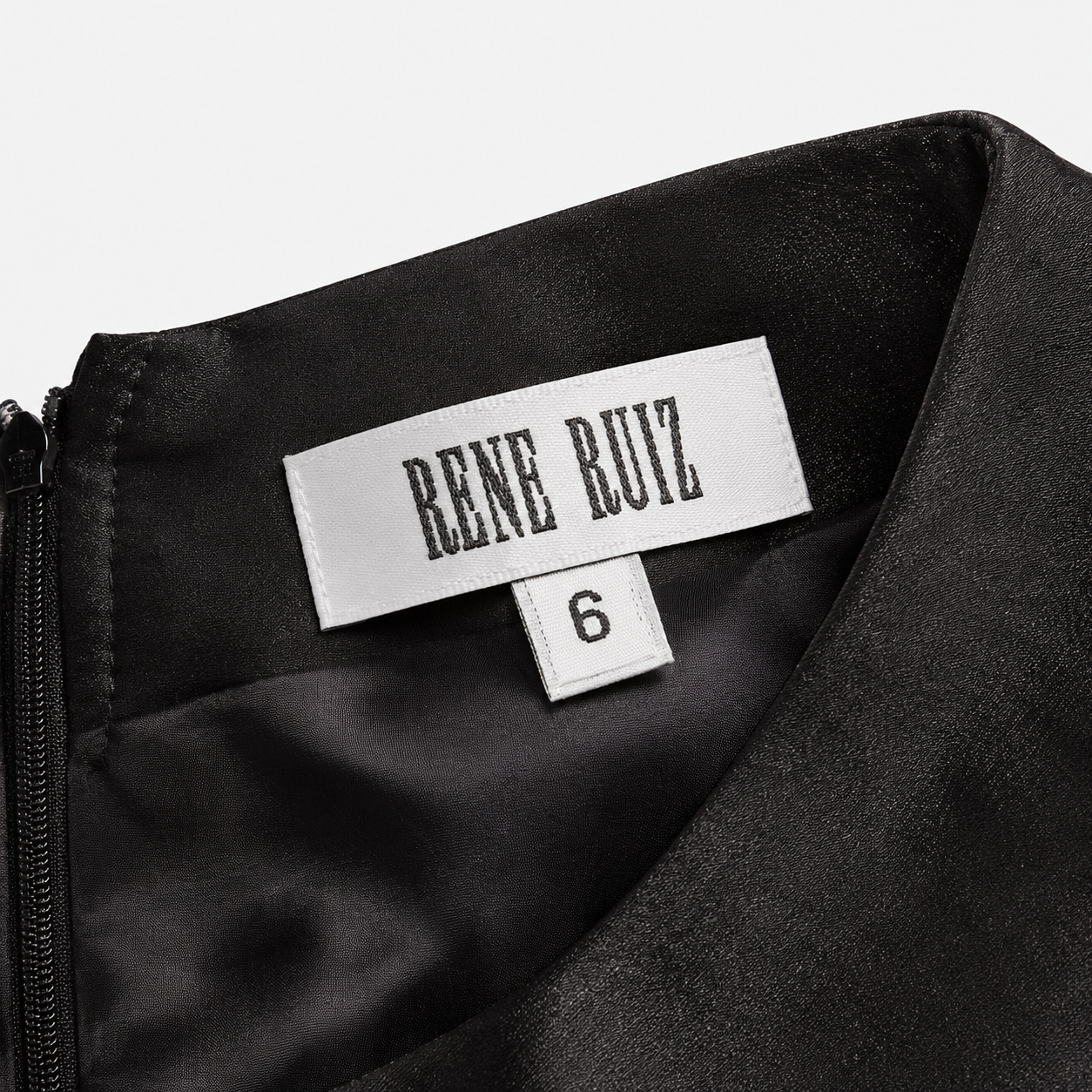 Black satin garment with 'Rene Ruiz' label on a white background