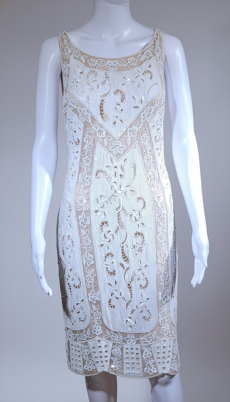 White lace dress on a mannequin against a gray background
