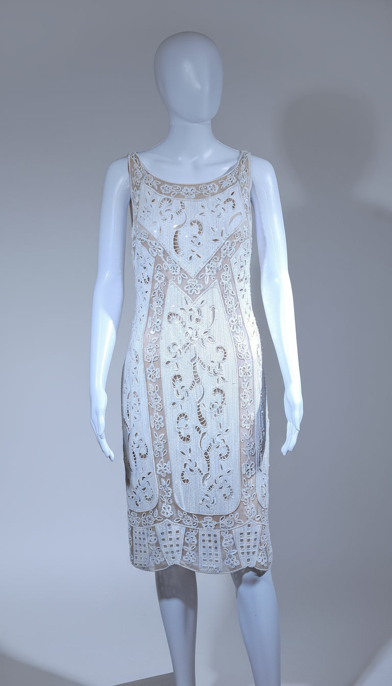 White lace dress on a mannequin against a gray background
