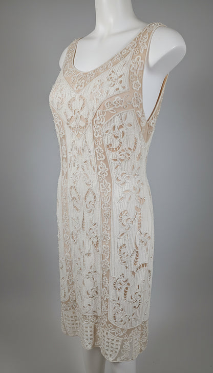 Lace dress on a mannequin against a gray background