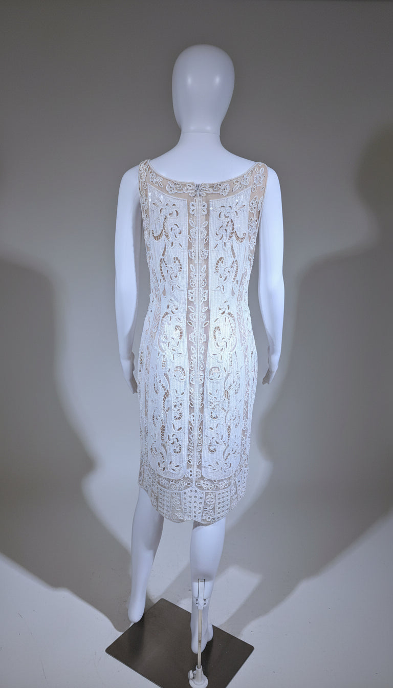 White lace dress on a mannequin against a neutral background