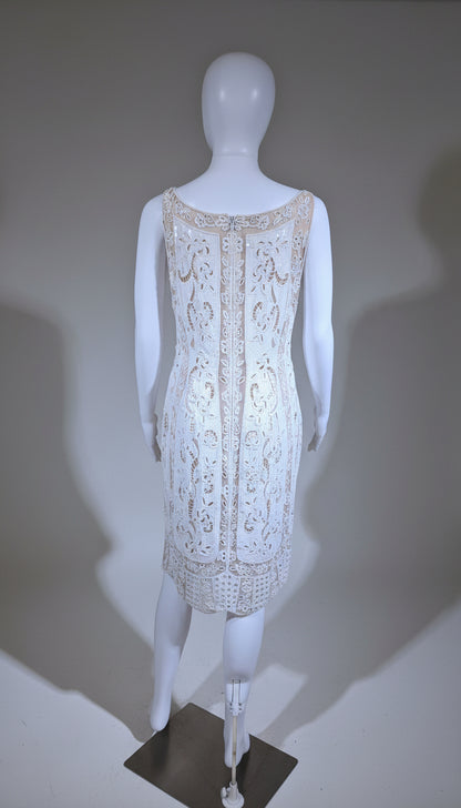 White lace dress on a mannequin against a neutral background