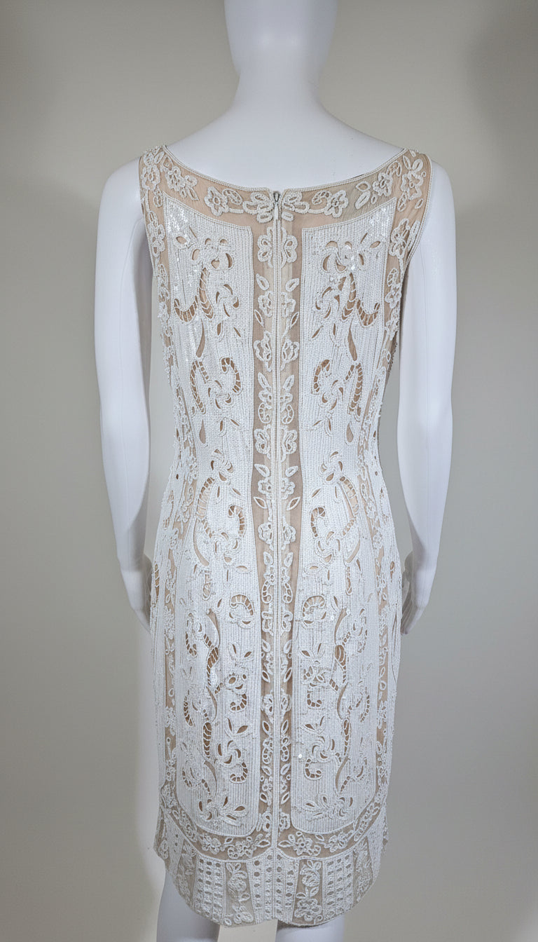 White lace dress on a mannequin against a plain background