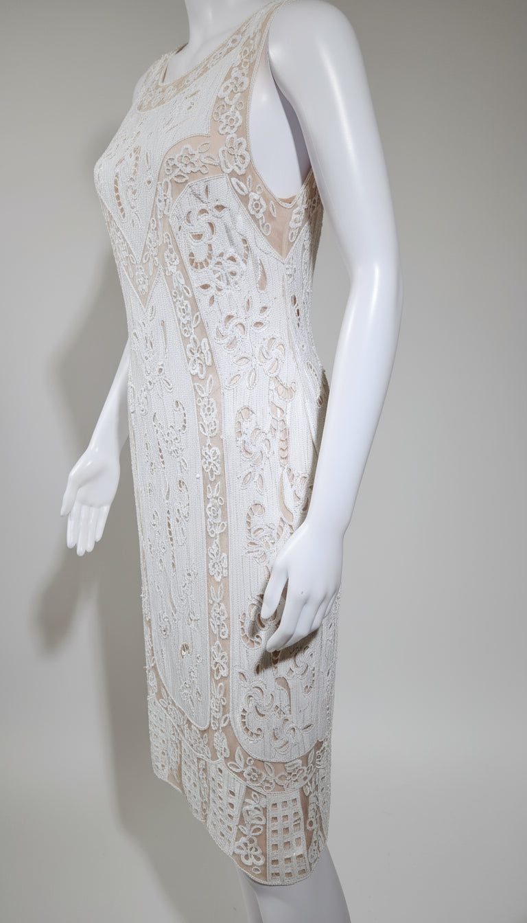 White lace dress on a mannequin against a plain background
