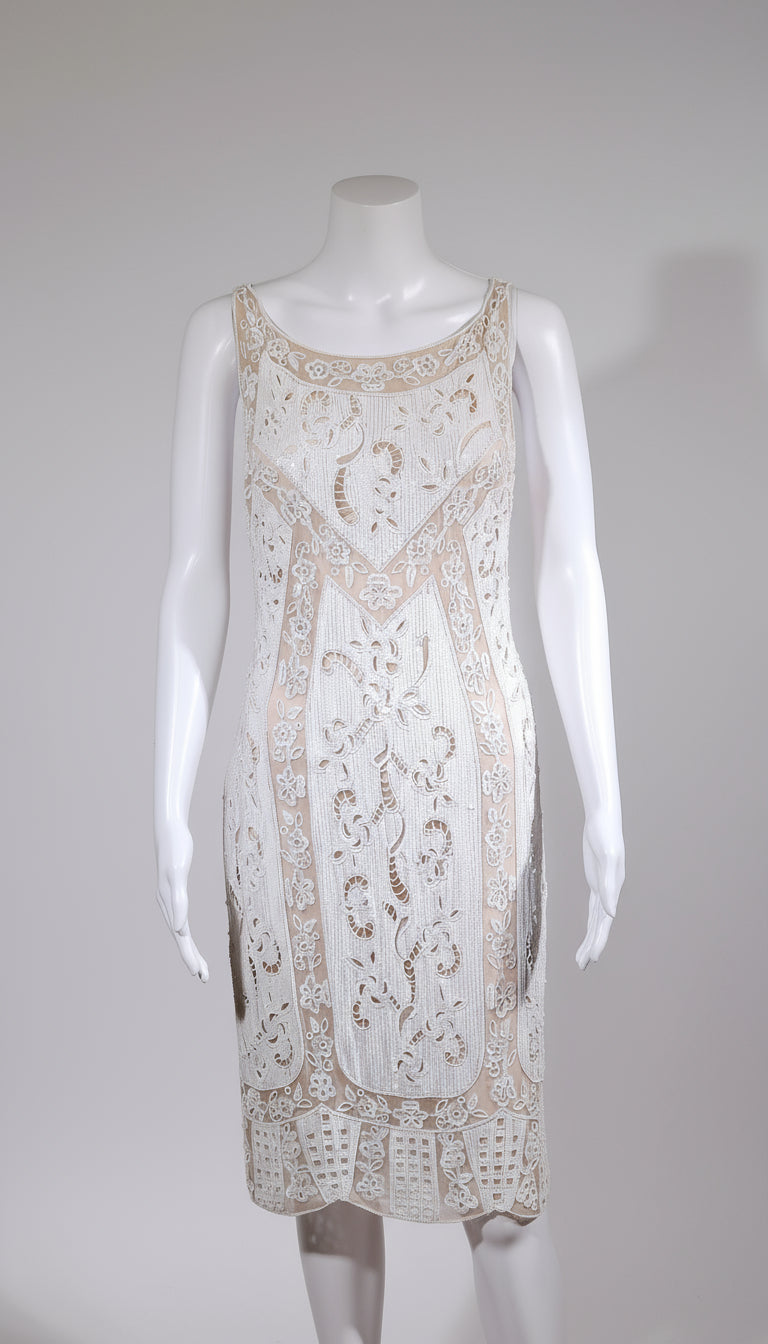 Lace dress on a mannequin against a plain background