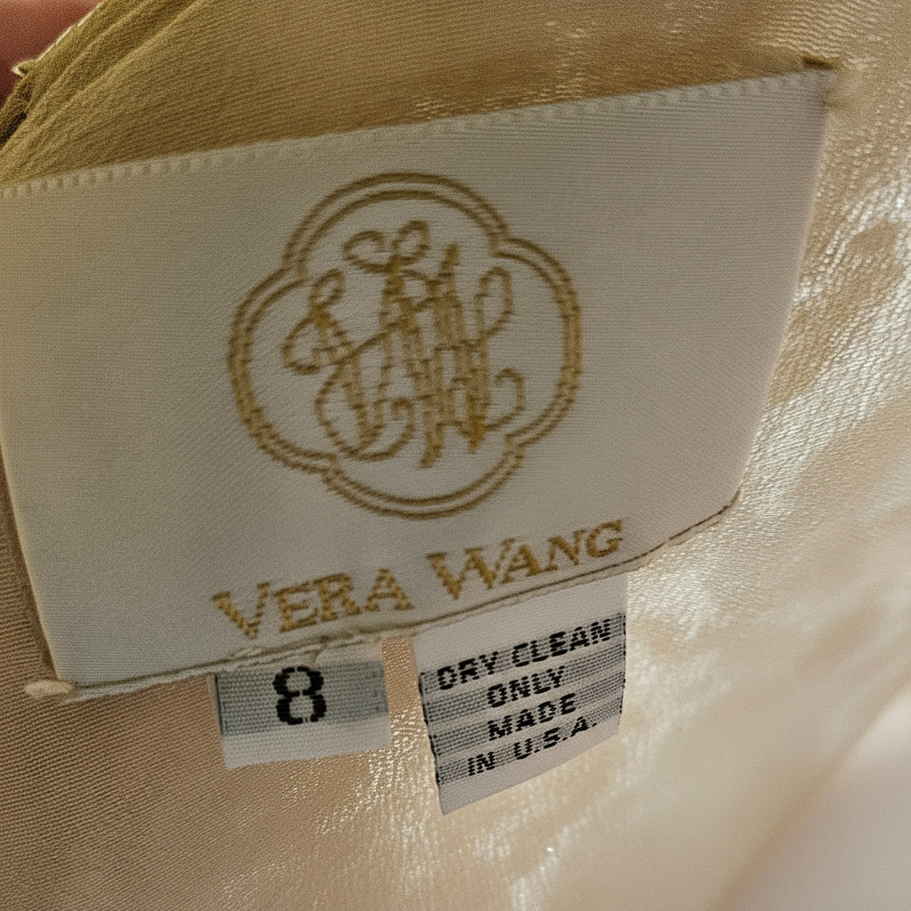 Close-up of a beige garment with a label featuring 'Vera Wang' branding.
