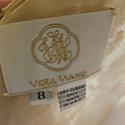Close-up of a beige garment with a label featuring 'Vera Wang' branding.