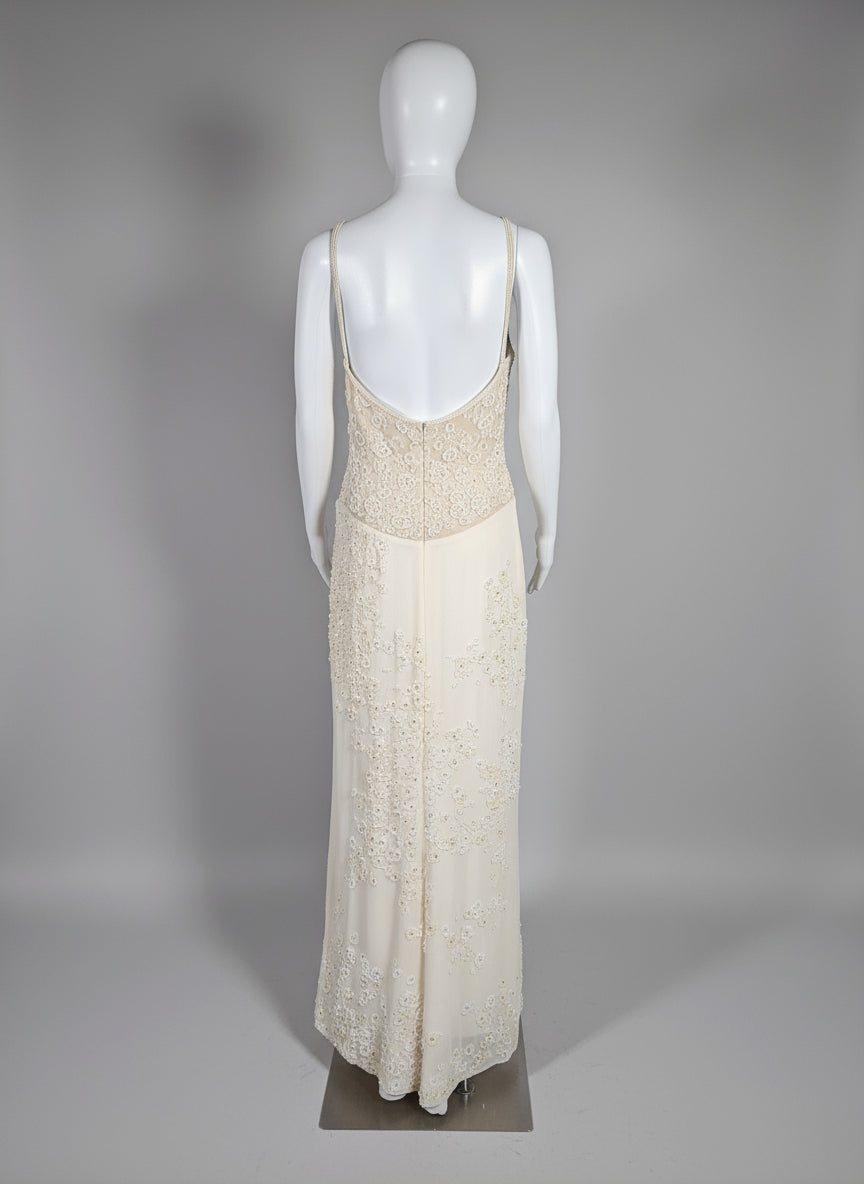 Mannequin wearing a beige lace dress against a gray background
