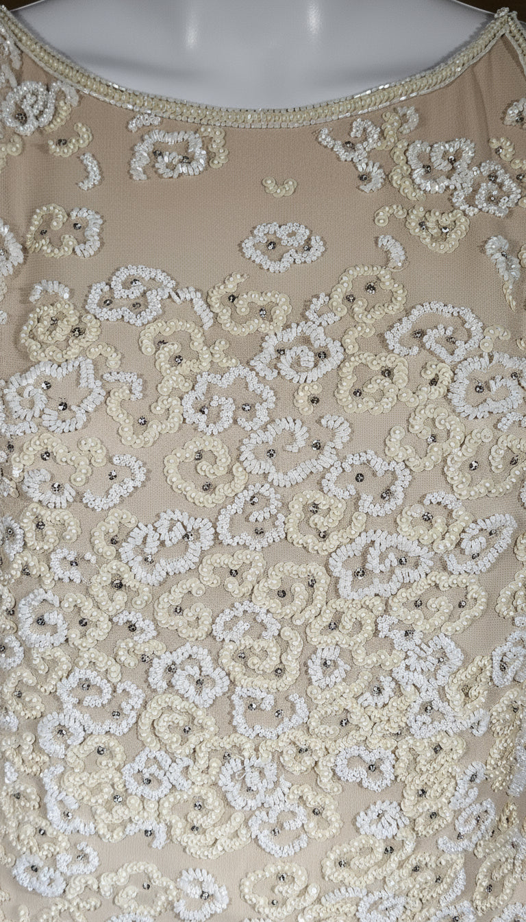 Beige fabric with intricate white floral embroidery