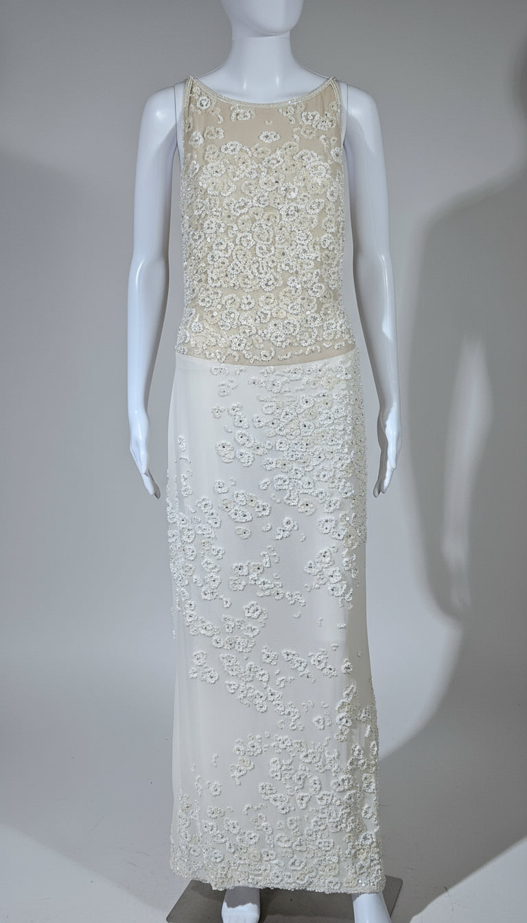 White lace dress on a mannequin against a gray background