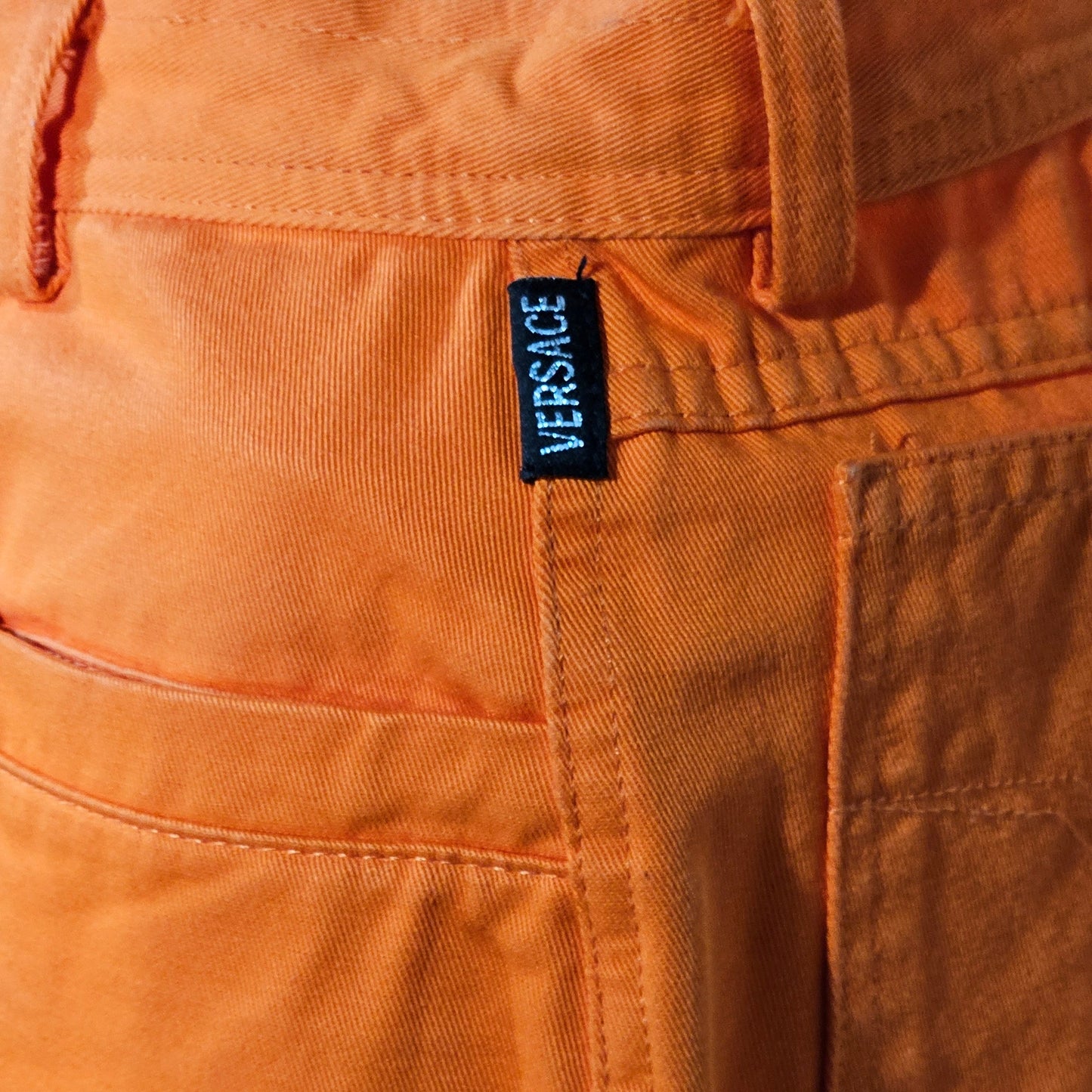 Close-up of  pants with a visible label on the pocket.