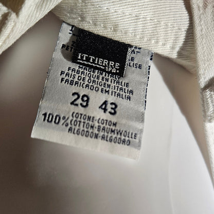 Close-up of a clothing tag with size information on a blurred background