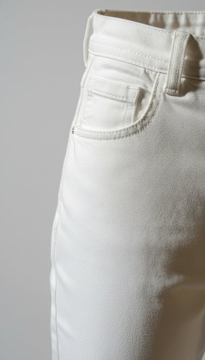 Close-up of beige pants with a visible stain on the fabric.