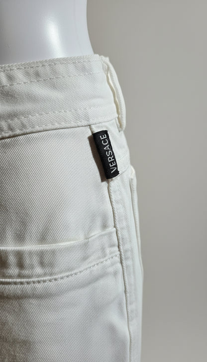 White Versace pants with a visible label on a gray background