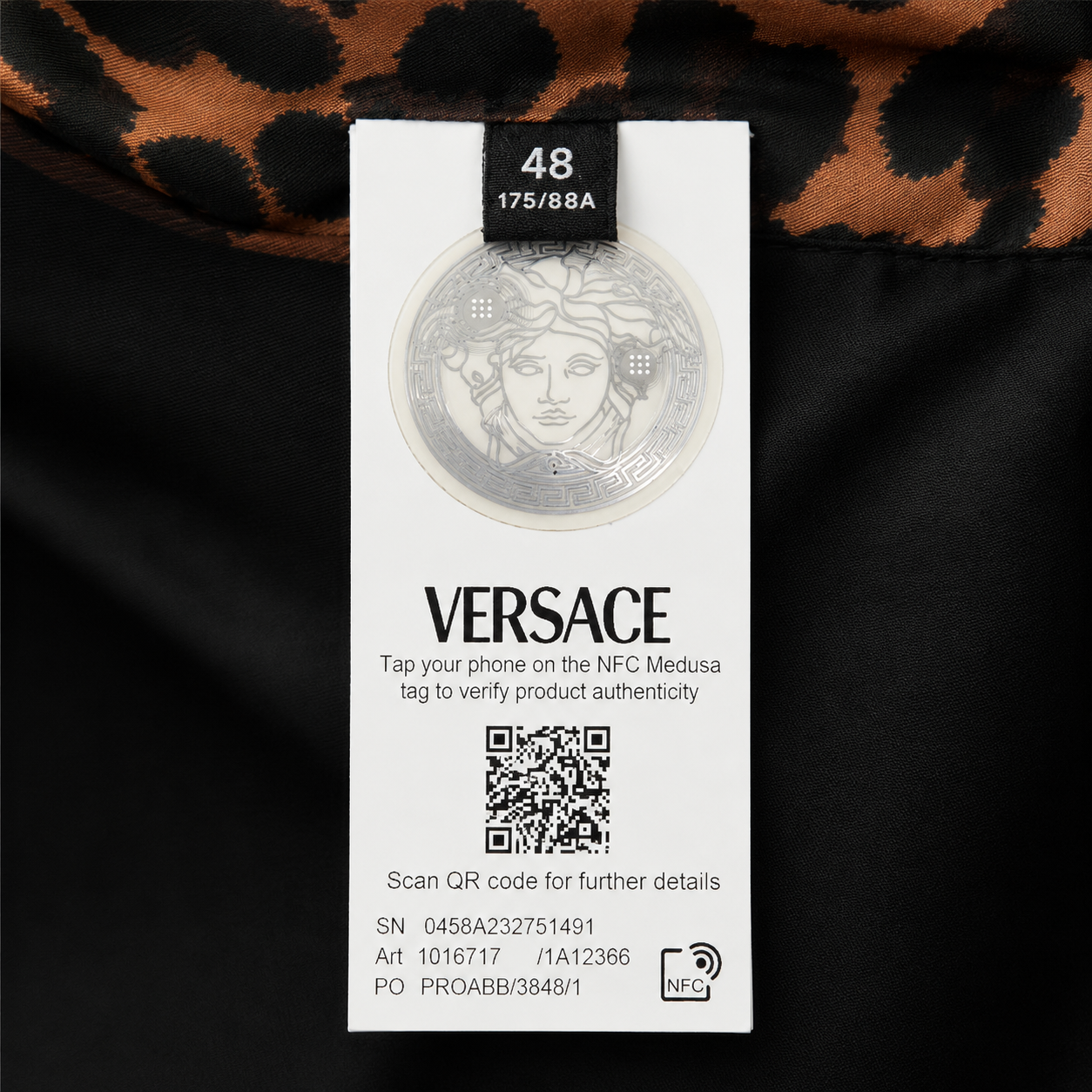 Versace label with NFC tag on a dark background
