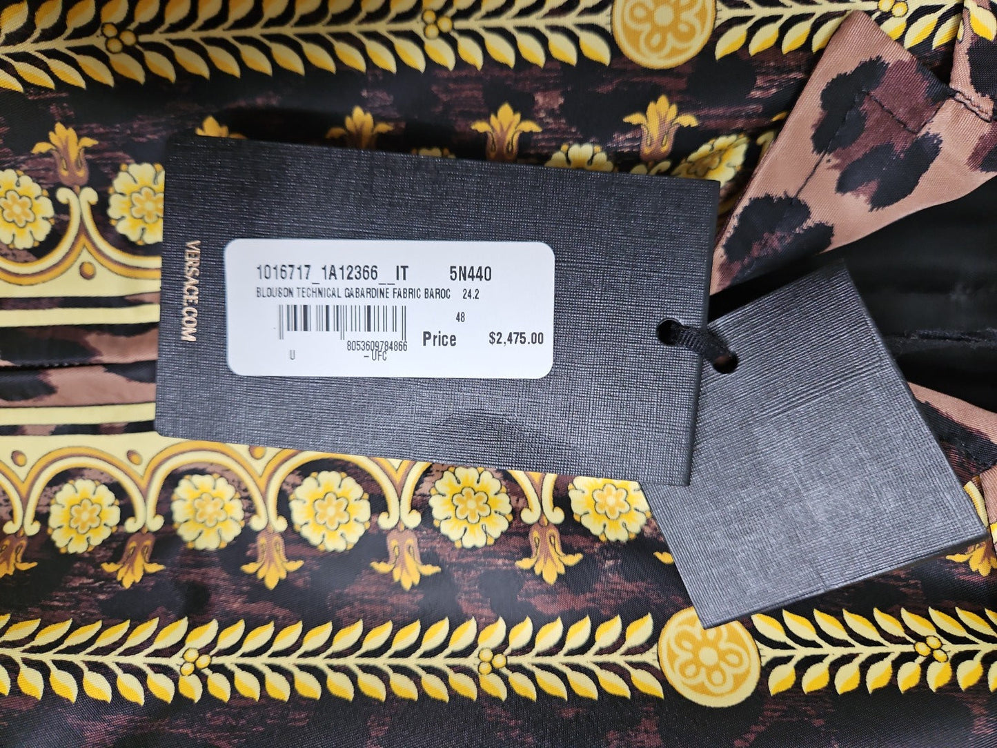 Versace label on a patterned fabric background
