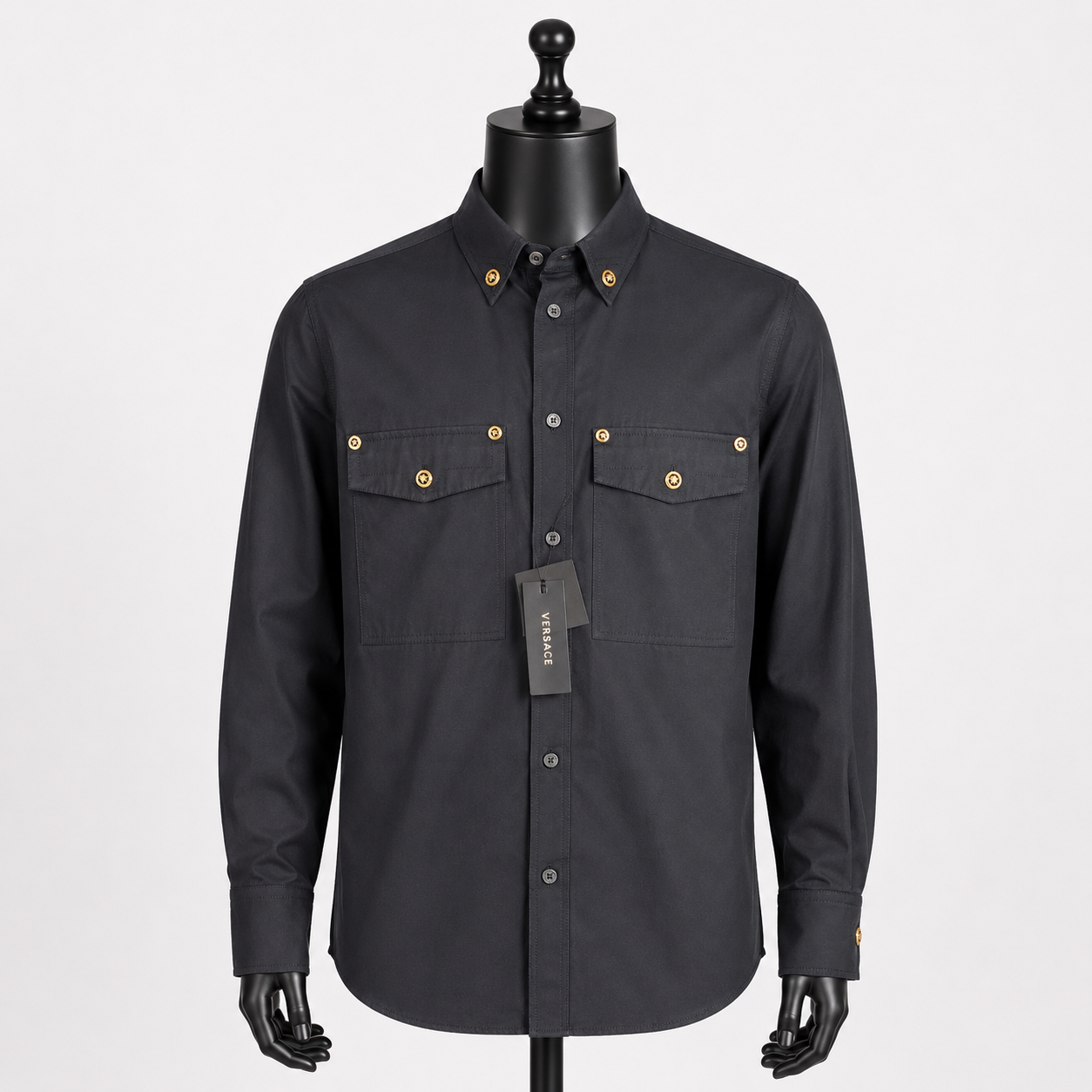 Loved By Lea: Versace Tribute Collection black poplin cotton shirt front view on mannequin showing gold Medusa head buttons at collar and dual chest pockets — new with tags