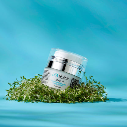 A container of Lea Black Beauty® Premium Hemp Soothing Eye Cream on top of a pile of alfalfa sprouts