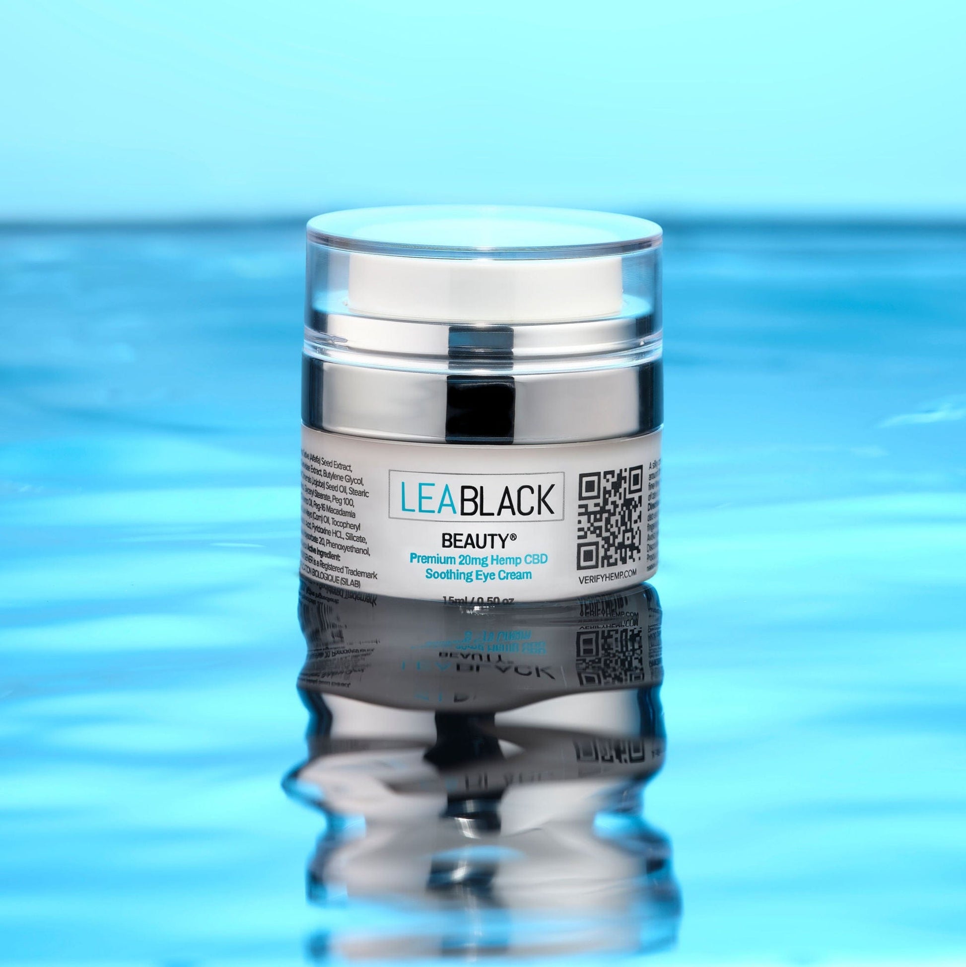 A container of Lea Black Beauty® Premium Hemp Soothing Eye Cream floating on top of serene water