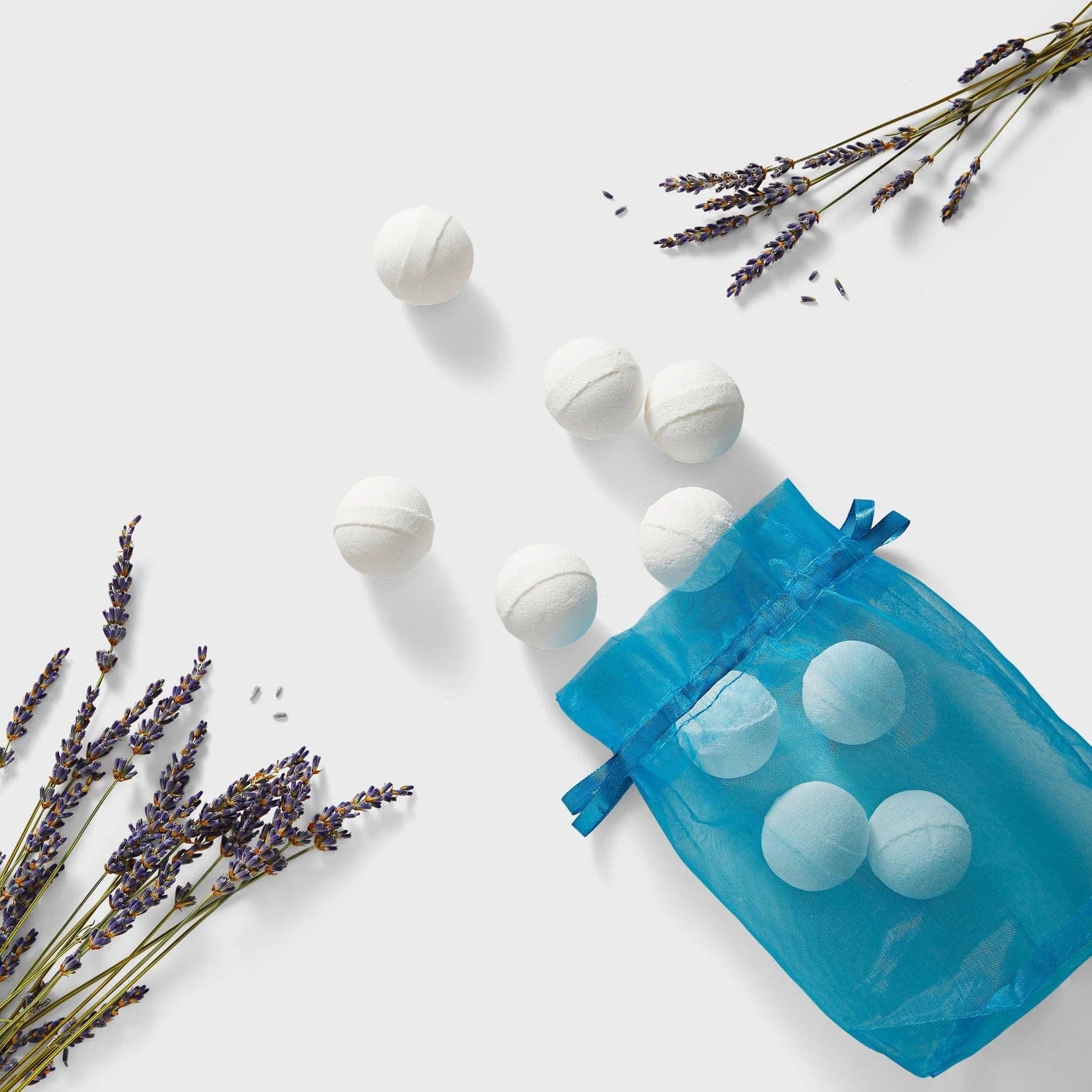 Lea Black Beauty® CBD bath bombs in a bag next to fresh lavender