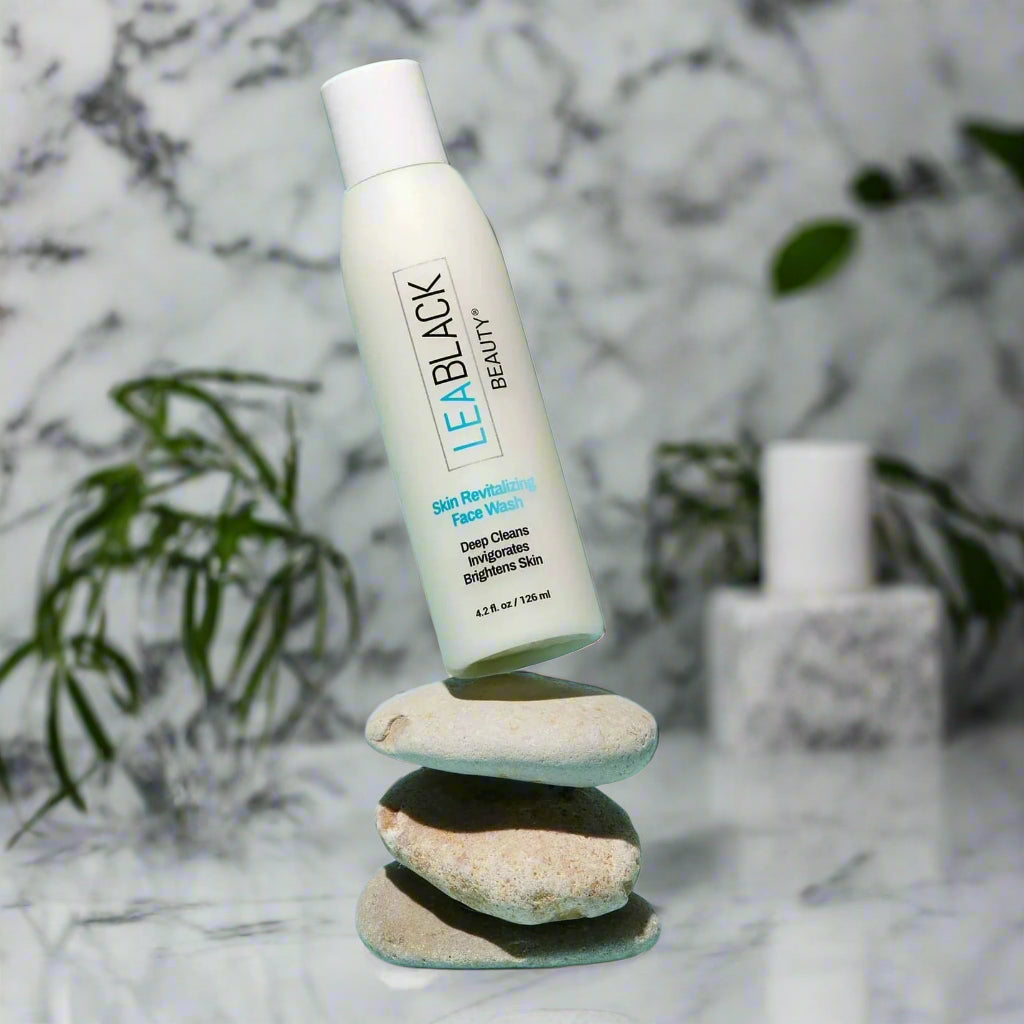 A bottle of Lea Black Beauty® Skin Revitalizing Daily Face Wash on a stack of three stones