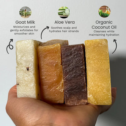 Four natural goat milk soaps on a hand