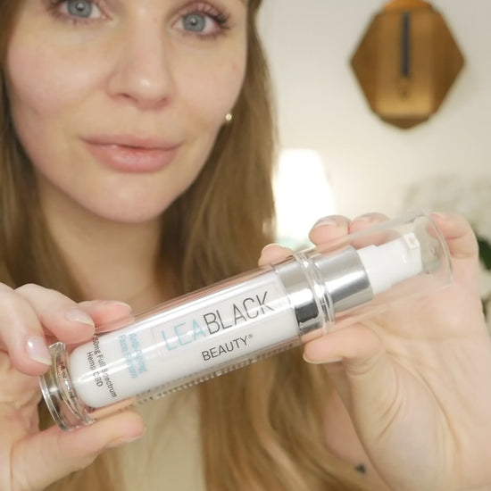 Leslie applying Lea Black Beauty Anti-Aging Face Serum with 250mg CBD to her face and neck.