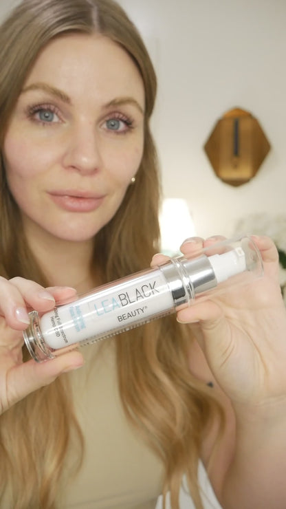Leslie applying Lea Black Beauty Anti-Aging Face Serum with 250mg CBD to her face and neck.