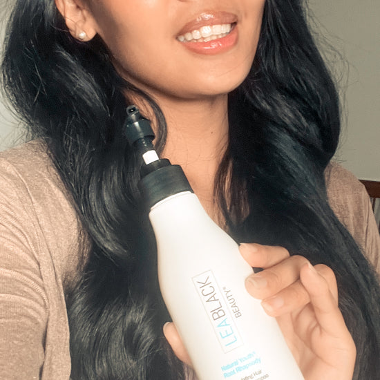 Pri washing her long dark hair with Natural Youth Root Rhapsody Shampoo Concentrate and displaying the soft, shiny finished results.
