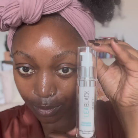 Arielle Bines applying Lea Black Beauty CBD face serum and daily moisturizer.