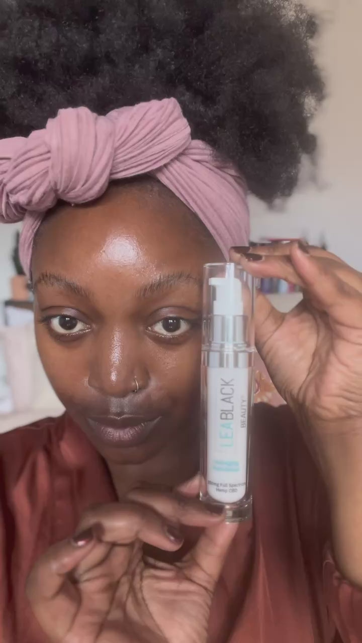 Arielle Bines applying Lea Black Beauty CBD face serum and daily moisturizer.