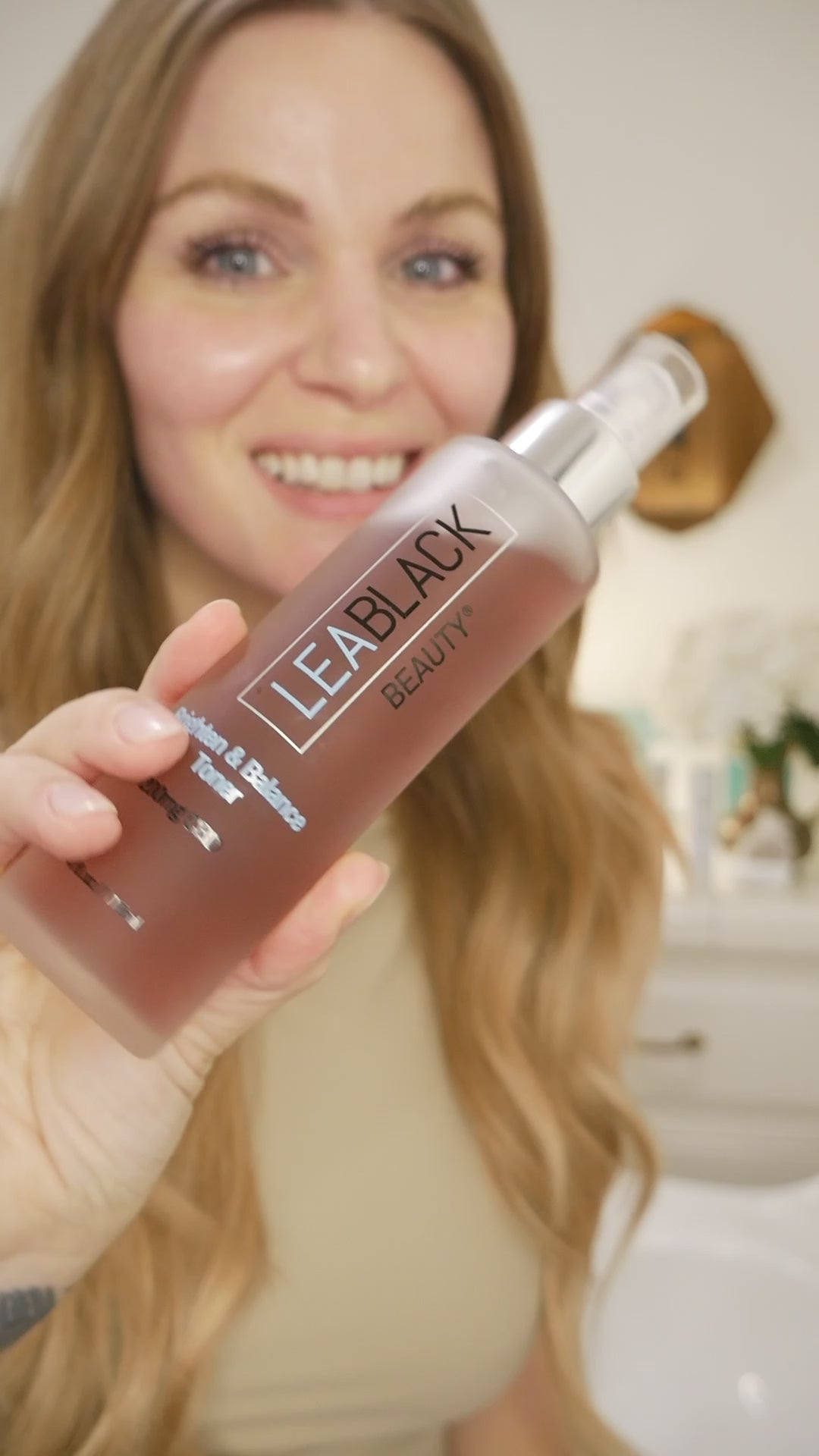Leslie applying Lea Black Beauty Brighten and Balance 200mg CBD Skin Toner to her face with a cotton pad.